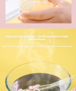 Heat-resistant glass straw shown in boiling water for sterilization with cute pink toppers