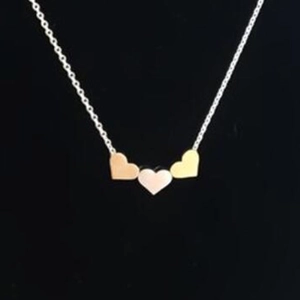 Three-heart pendant necklace with gold and rose gold charms on thin silver chain