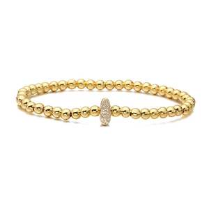 Detail of 18K gold plated beaded bracelet featuring a sparkling zircon pavé oval charm