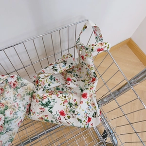 Detailed macro view of floral cotton canvas tote bag texture inside a metal basket