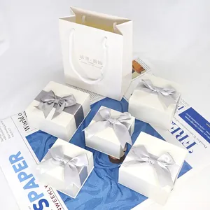 Elegant jewelry gift box set with silver bow ribbons and matching paper carrier bag