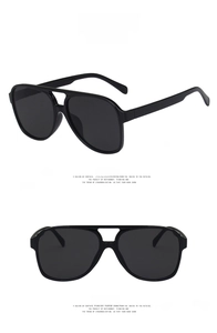 Detail view showing front and side profiles of oversized black aviator sunglasses