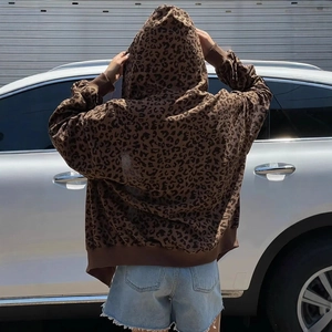 Detail of oversized leopard print hoodie showing ribbed corduroy texture and zip closure