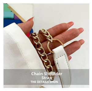 Detailed close-up of the gold chain and white leather shoulder strap for crossbody bags