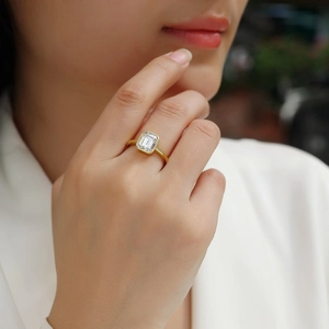 Minimalist 925 silver ring in gold finish with rectangular cut moissanite on finger