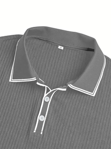 Close-up of gray men's polo shirt featuring ribbed fabric texture and white buttons