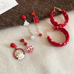 Detail of red festive earring set featuring pearl pendants and lucky character charms