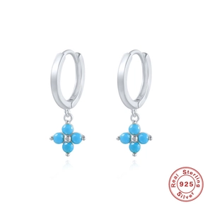 Macro detail of S925 sterling silver hoop earrings with blue snowflake flower charms