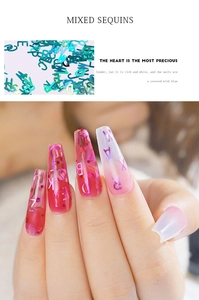 Macro detail of holographic laser letter sequins for nail art decoration and mixed shapes