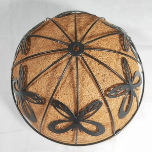 Detail of hanging iron basket with butterfly pattern and coconut palm fiber liner