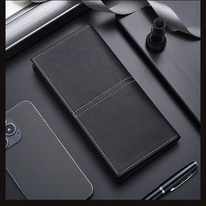 Detail of slim black leather wallet with white stitching and premium business accessories