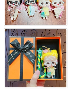 Close-up of cute cartoon doll keychain with orange gift box and ribbon decoration