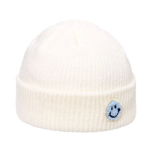 Detailed close-up of thick white knitted beanie texture with blue smile face patch