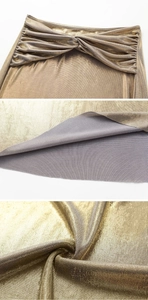 Detail of gold metallic knit fabric with elegant knot design and pleated texture layers