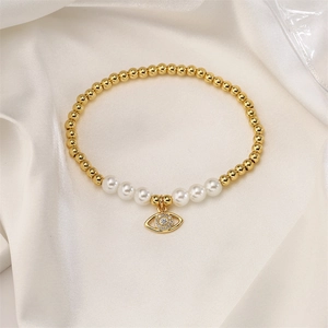 Detailed view of evil eye bracelet with 4mm gold copper beads and white pearls