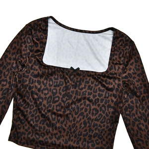 Close-up of leopard print top with square neckline and small black bow detail