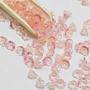 Macro detail of lily of the valley glass beads in pink gradient for DIY jewelry making