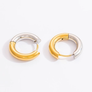 Detailed macro view of 18k gold and silver two-tone link earrings with polished finish