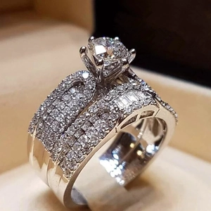 Macro view of a three-piece engagement ring set with a round brilliant-cut main stone