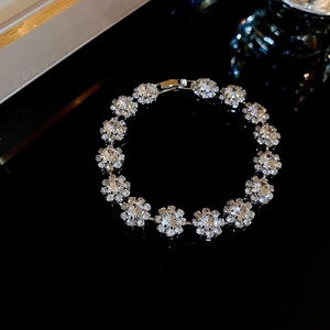 Macro shot of silver flower link bracelet with sparkling crystals on dark surface