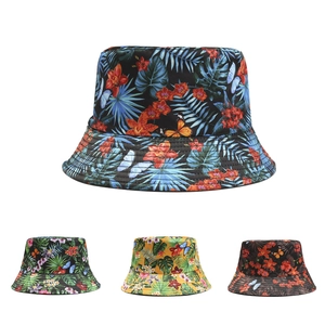 Detail showing various reversible bucket hats with tropical plant and butterfly prints