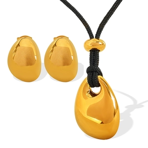 Golden punk style water drop jewelry set with necklace and earrings on white background
