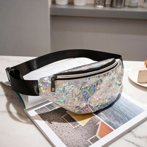 Silver holographic sequin waist bag with adjustable strap on a marble surface