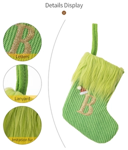 Detail display of green knit Christmas stocking with letter B and faux fur cuff