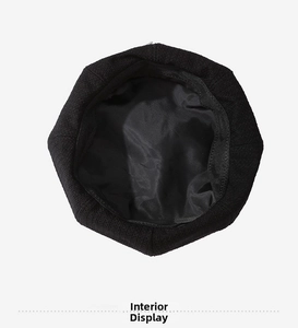 Detail shot of the black beret featuring a silky satin lining and fine knitted wool texture