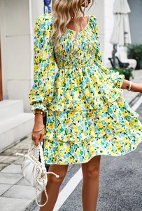 Detailed close-up of smocked bodice and long puff sleeves on floral mini dress