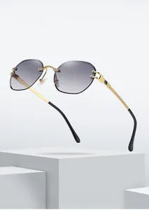 Close-up of diamond-cut gray gradient lenses and engraved gold metal bridge detail
