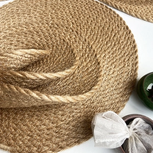 Handwoven round jute placemat with natural brown texture for heat-resistant dining decor