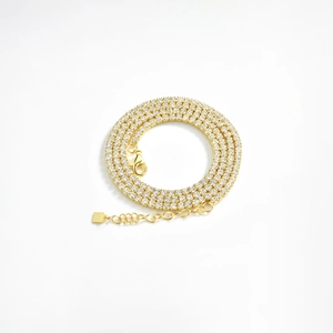 Detail of three-row gold S925 silver tennis chain with clear cubic zirconia crystals