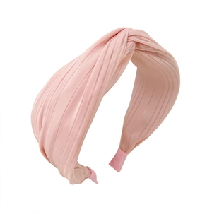 Elegant pink pleated fabric headband with knot detail for a sophisticated french style look