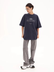 Full body shot of casual oversized cotton T-shirt in navy blue with white printed text