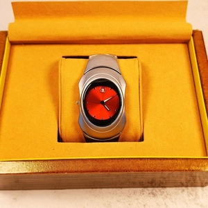 Y2K millennium style men's quartz watch with asymmetric silver case and red sunburst dial