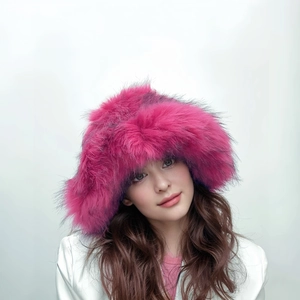 Detail of hot pink oversized faux fur hat showing soft plush texture and thick volume