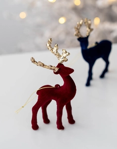 Detail of red and blue flocked Christmas reindeer ornaments with gold glitter antlers