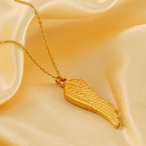 Elegant 18K gold-plated angel wing pendant necklace on silky gold satin background