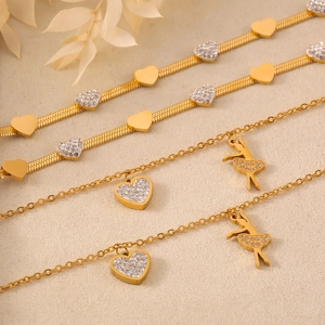 Elegant gold heart and ballerina pendant bracelet with inlaid crystals on layered chains