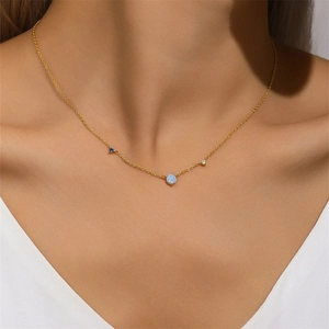 Close-up of a gold s925 silver necklace with blue opal and sparkling diamond accents