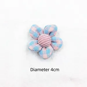 Close-up of 4cm pink and blue plaid fabric flower accessory with corduroy center