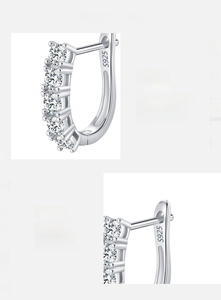 Detailed macro view of S925 sterling silver stamp and VVS1 Moissanite stones on earrings