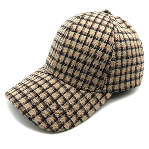 Detail shot of the vintage brown plaid pattern and fine stitching on the baseball cap