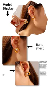Detail of C-shaped gold-plated titanium earrings with white pearls on a model