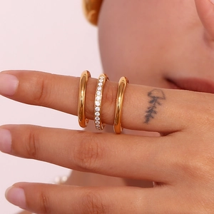 Close-up of three 18K gold-plated stainless steel rings with clear zircon stone on finger