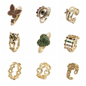 Set of nine golden minimalist crown and zircon open rings with butterfly and star motifs
