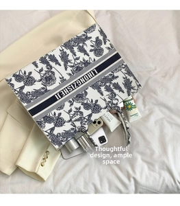 Interior view of floral felt tote bag showing spacious capacity for phone and accessories