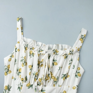 Close-up of floral sundress with lemon print, ruffled neckline, and drawstring detail