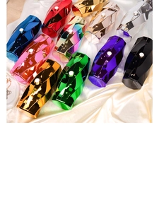 Detailed view of colorful irregular acrylic clutch bags with metallic faceted finish